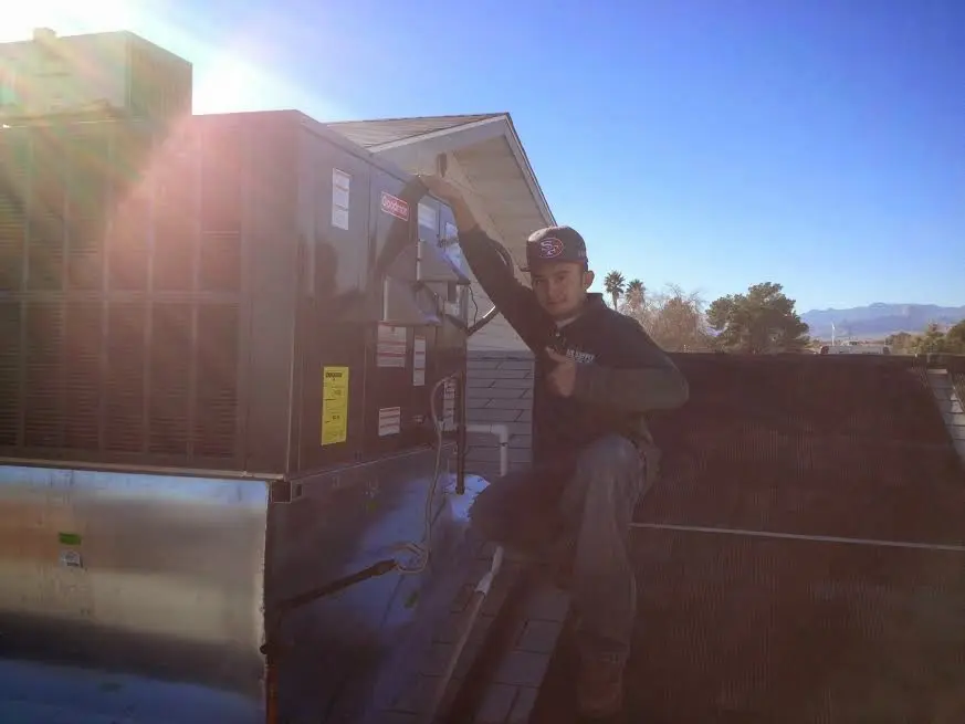 HVAC technician performing Heat Pump Repair on a rooftop unit in Collingswood
